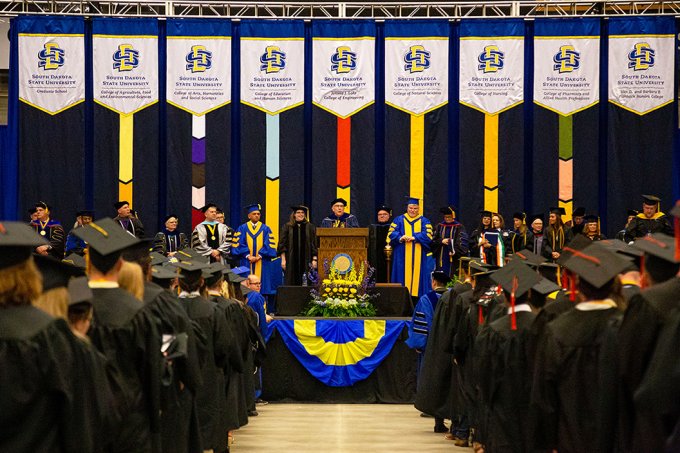 One of the 2023 South ֱ State University commencement ceremonies at the Dacotah Bank Center in Brookings is show, with SDSU President Barry Dunn addressing graduates.